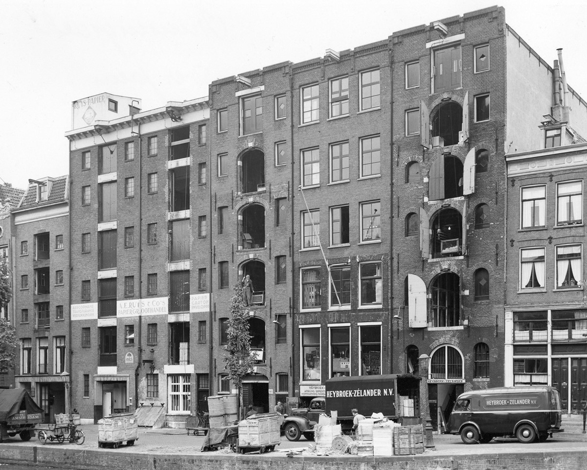 An old black and white photograph of a multi-windowed building, showcasing its historical significance.