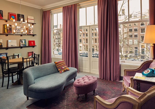 A stylish living room adorned with purple curtains and a plush couch, enhancing the space's comfort and aesthetic appeal.