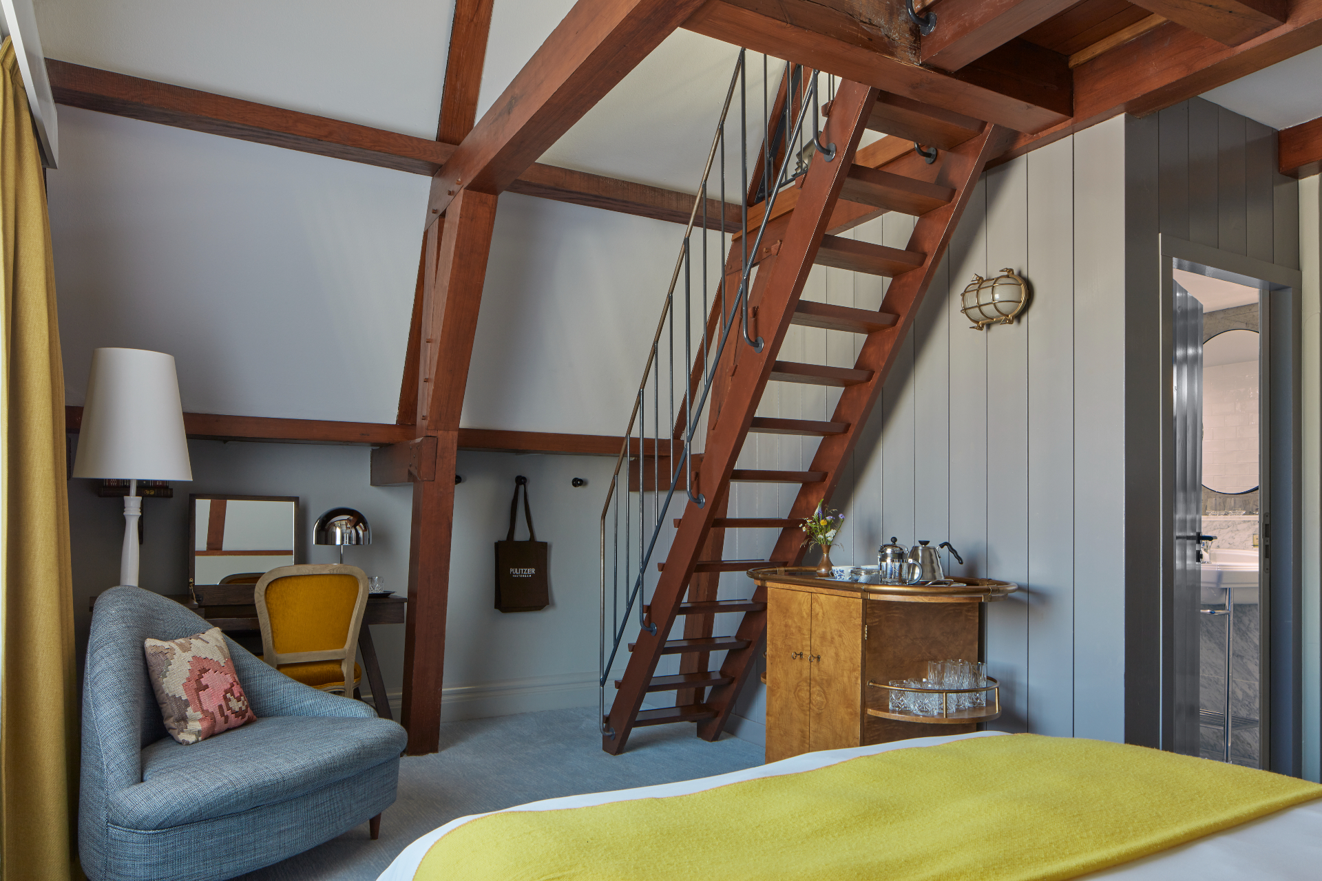 An inviting bedroom with a ladder extending to the top, creating an interesting focal point and maximizing the room's height.