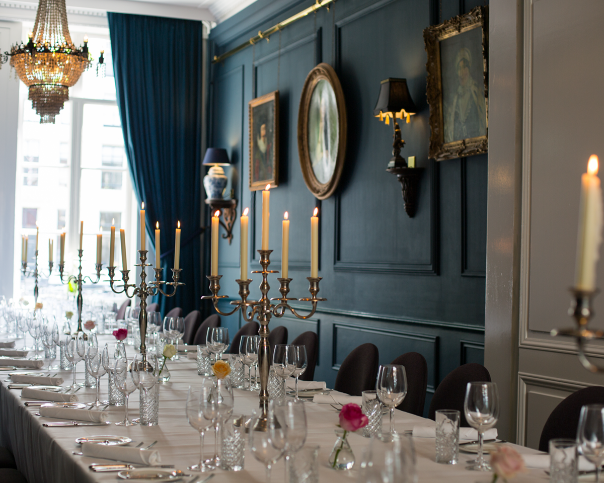 A long table set in a spacious room, showcasing its extended length and elegant design.