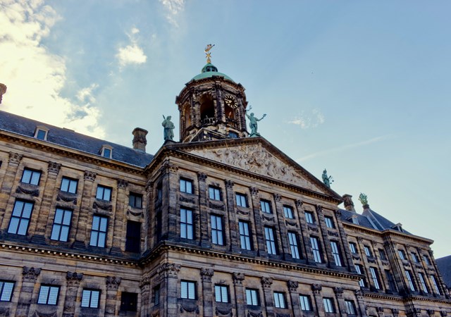 A view of the royal palace in Amsterdam, highlighting its majestic facade and cultural importance as a landmark.
